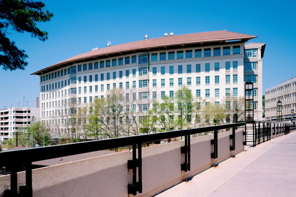 Modern office building with large windows and rooftop antennas.